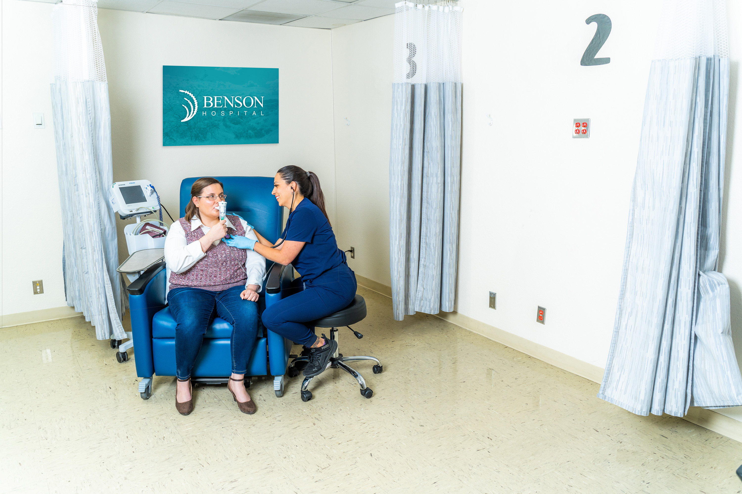 A provider works with a patient in Benson Hospital